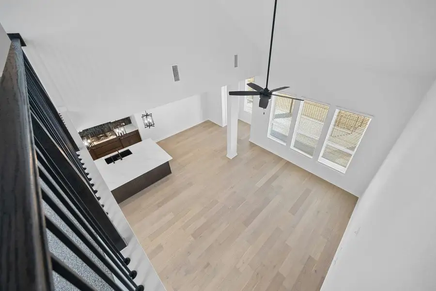 Unfurnished living room featuring light wood-style floors and ceiling fan Unfurnished living room featuring light wood-style floors and ceiling fan
