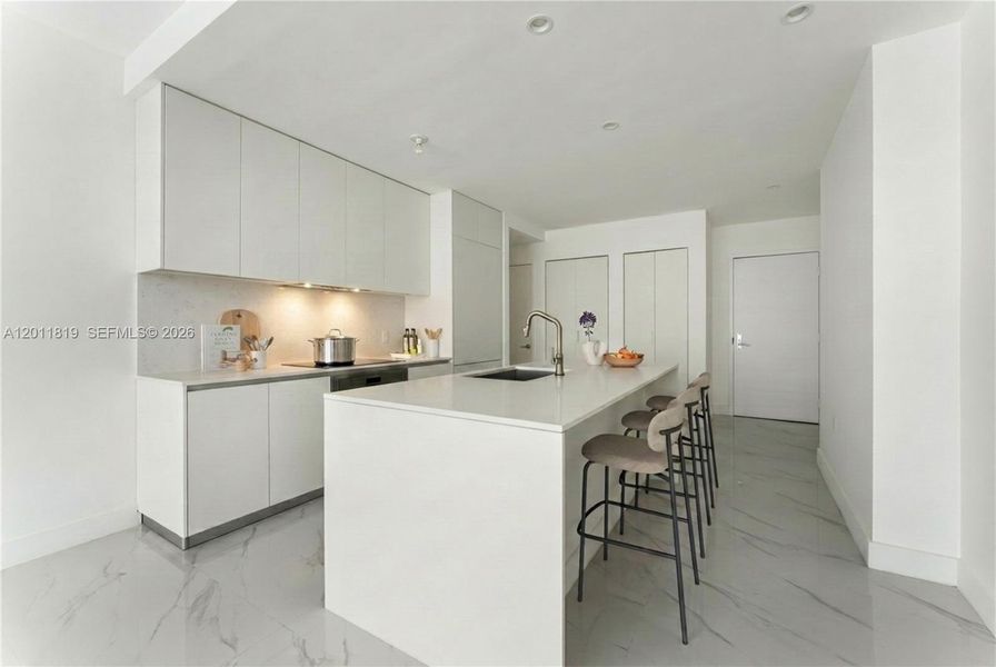 Modern chef’s kitchen equipped with custom Italian cabinetry, premium Miele appliances, integrated stone countertops, and a waterfall island perfect for entertaining. Image i virtually staged.