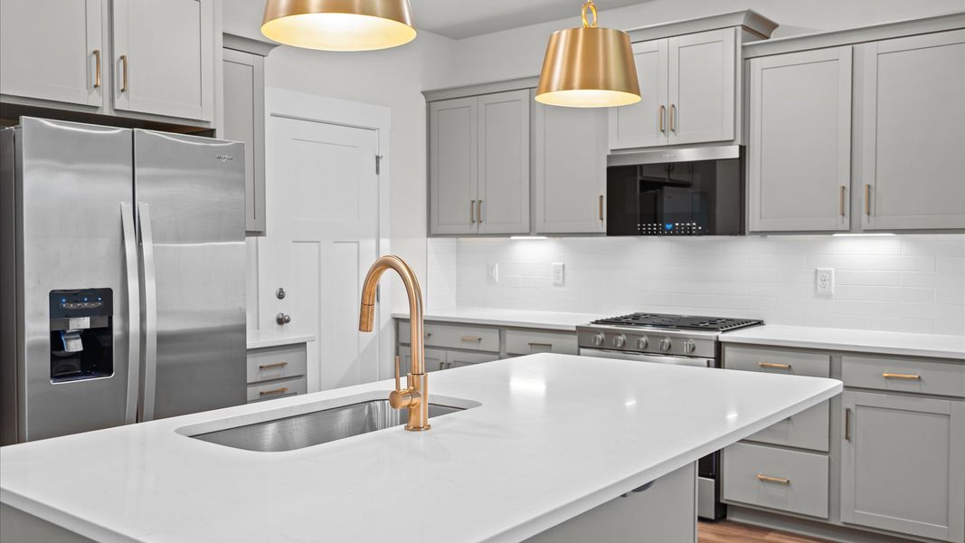 Vibrant kitchen layout with a center island, refined finishes & open-concept flow at Silo Ridge by DRB Homes in Anderson, SC
