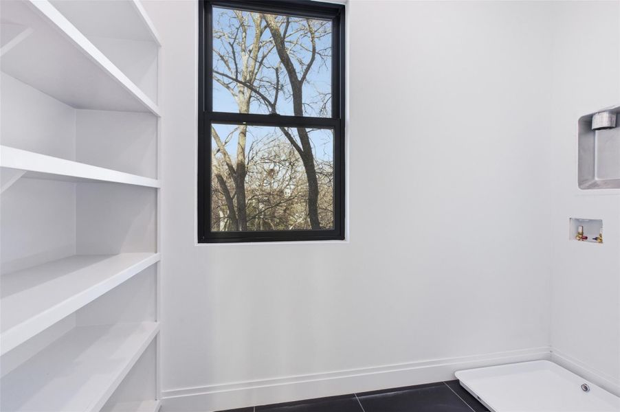 Utility Room with shelving and natural lighting.