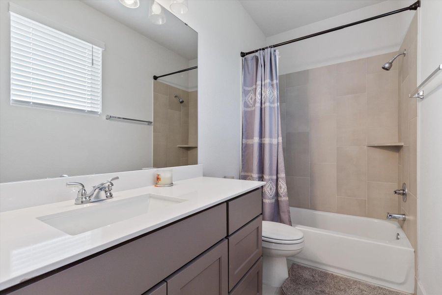 Full bathroom featuring shower / tub combo and vanity