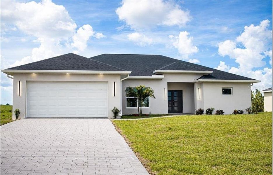 Front exterior of a new home in , Cape Coral, FL, highlighting curb appeal (Image 1). Front exterior of a new home in , Cape Coral, FL, highlighting curb appeal (Image 1).
