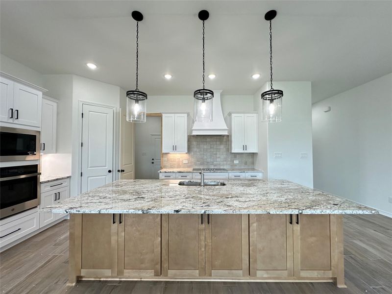 Kitchen featuring white cabinetry, light stone countertops, appliances with stainless steel finishes, dark wood finished floors, and recessed lighting