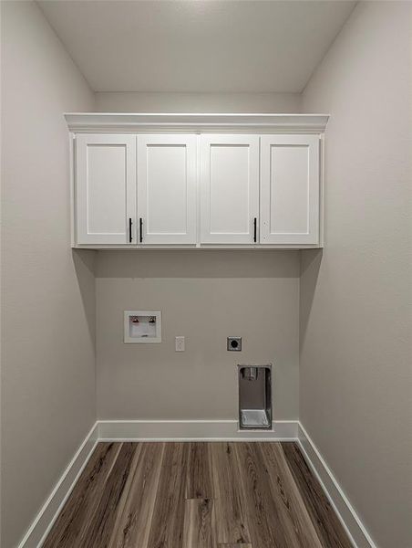 Laundry room with dark wood-type flooring, hookup for a washing machine, electric dryer hookup, and cabinet space Laundry room with dark wood-type flooring, hookup for a washing machine, electric dryer hookup, and cabinet space