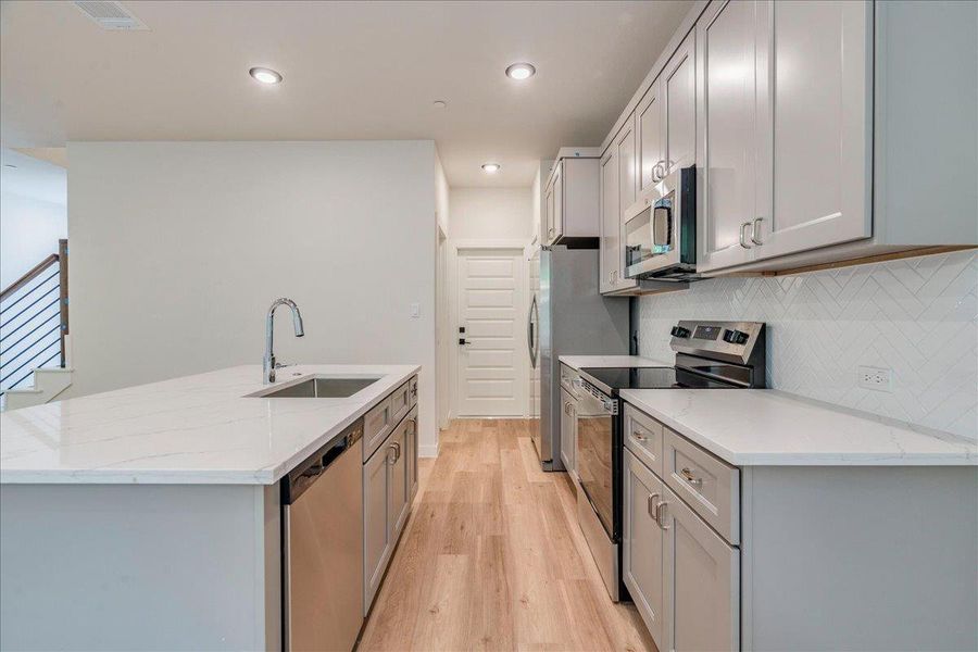 A well-appointed kitchen showcasing contemporary appliances and abundant counter space.