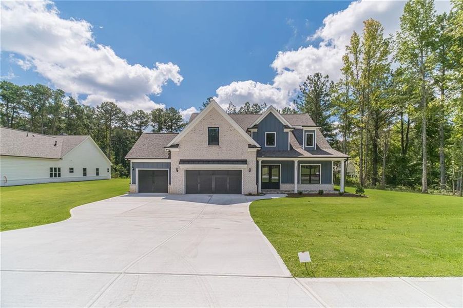 Front exterior of a new home in , Loganville, GA, highlighting curb appeal (Image 23).