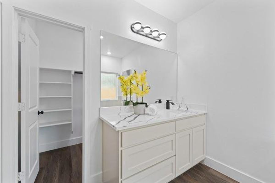 Dual vanity with a white-finish cabinet and stone-finish countertop Dual vanity with a white-finish cabinet and stone-finish countertop