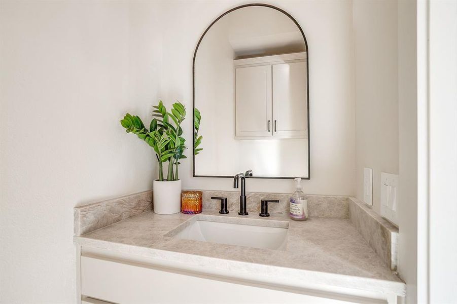 Sleek lighting and stone accents define this modern Fort Worth bathroom. Sleek lighting and stone accents define this modern Fort Worth bathroom.