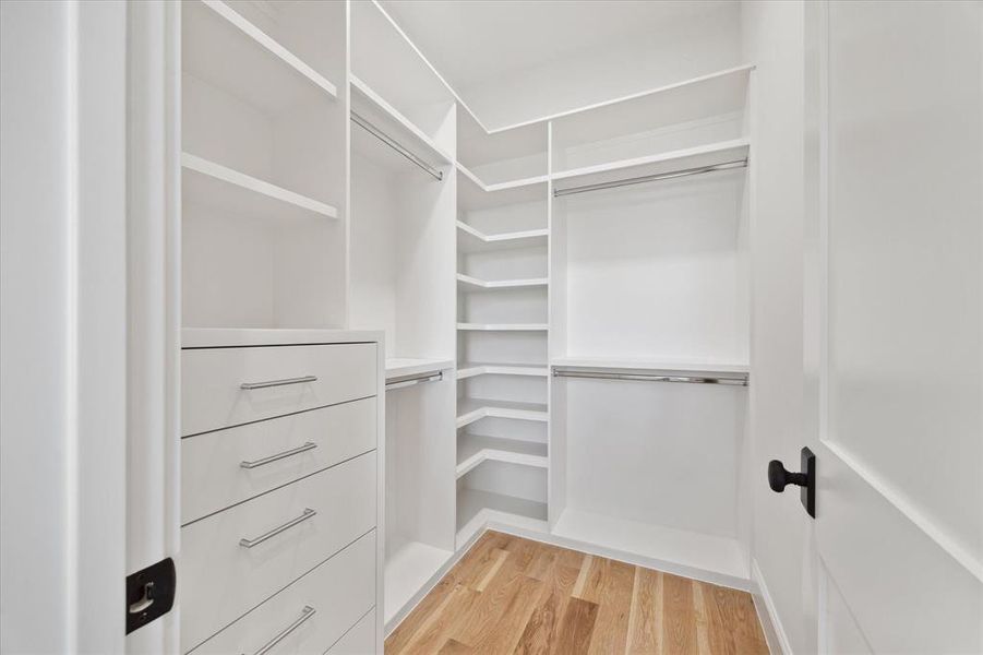 One of the upstairs secondary closets. All closets are walk-ins and have built-ins and aluminum rods.