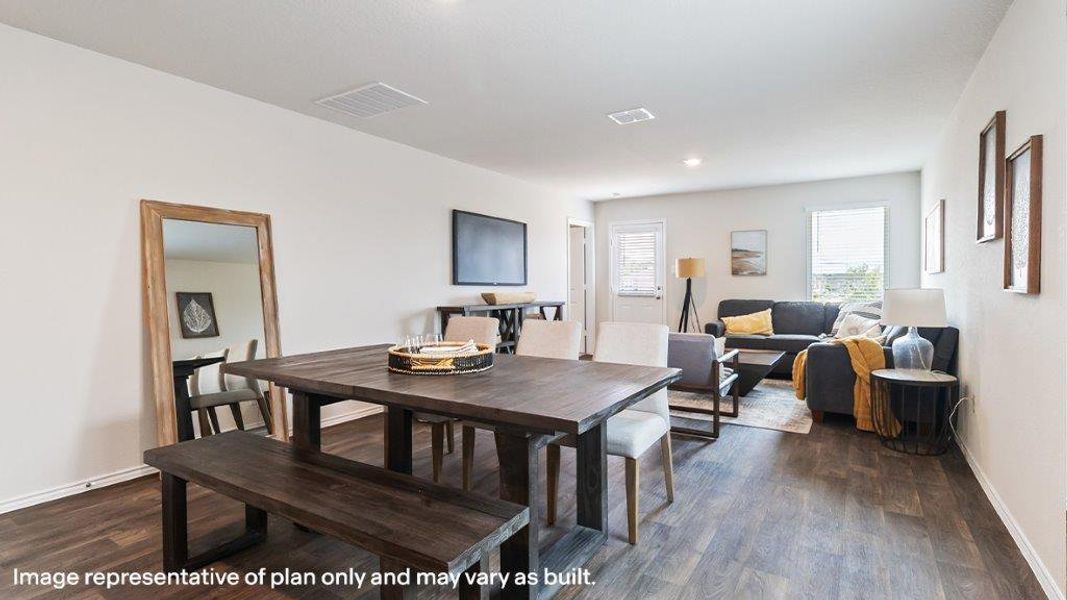 An open concept living and dining area boasts rich wood flooring and ample natural light. An open concept living and dining area boasts rich wood flooring and ample natural light.