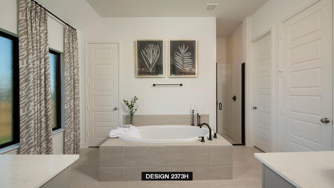 Bathroom with vanity, a garden tub, and a stall shower Bathroom with vanity, a garden tub, and a stall shower