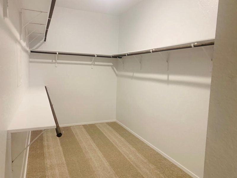 Primary Bedroom Walk-in Closet Primary Bedroom Walk-in Closet
