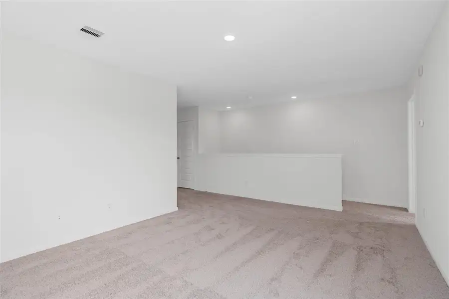 Another perspective of the Loft, showcasing the staircase, entry to primary bedroom on the right, and hallway on the left to secondary bedrooms and bathroom. Another perspective of the Loft, showcasing the staircase, entry to primary bedroom on the right, and hallway on the left to secondary bedrooms and bathroom.