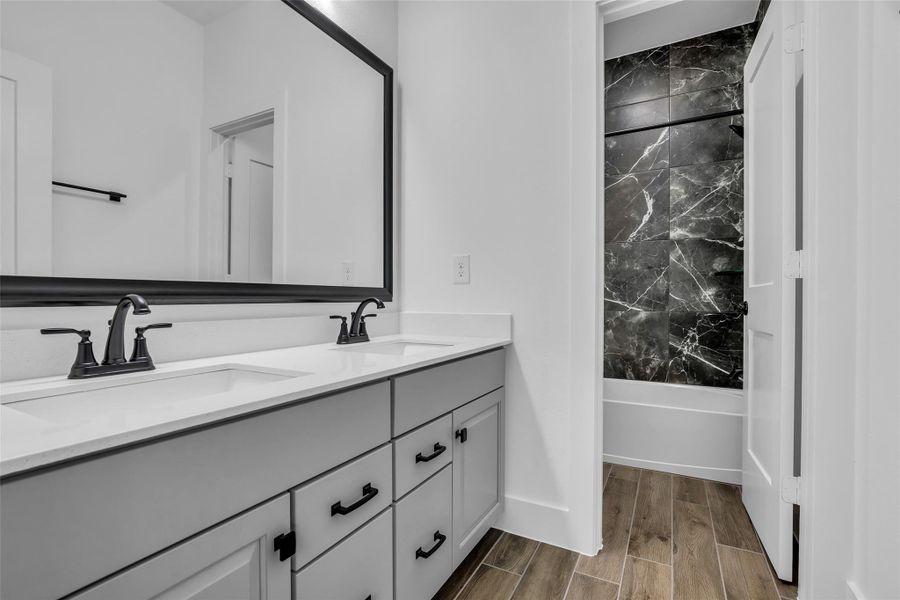 Hall Bath with double vanity, storage and separated Tub/shower combo and Toilet