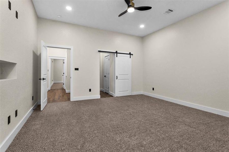 Another view of Bedroom 2 showing entrance into bathroom and walk-in closet area. Notice the barn door to completely shut off the whole area.