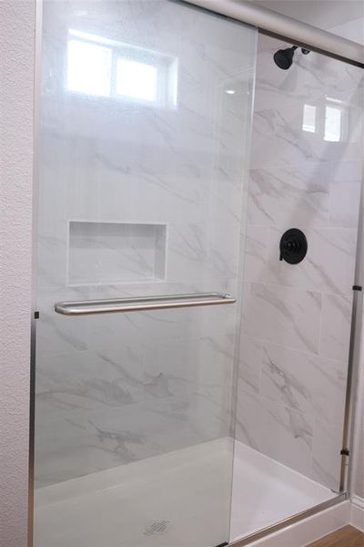 Full bath with a marble finish shower Full bath with a marble finish shower