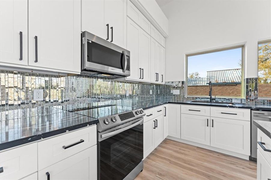 he modern kitchen is equipped with sleek stainless steel appliances, perfect for both everyday cooking and entertaining.