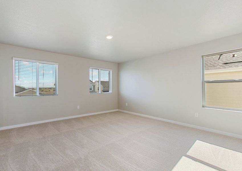 The master bedroom is spacious with large windows.