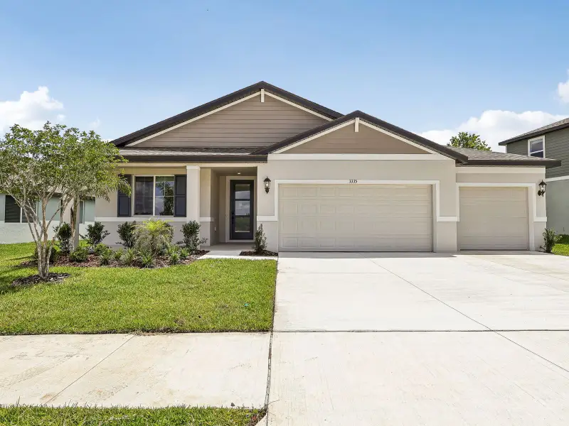 Front exterior of a new home in The Grove at Stuart Crossing - Signature Series, Bartow, FL, highlighting curb appeal (Image 1). Front exterior of a new home in The Grove at Stuart Crossing - Signature Series, Bartow, FL, highlighting curb appeal (Image 1).