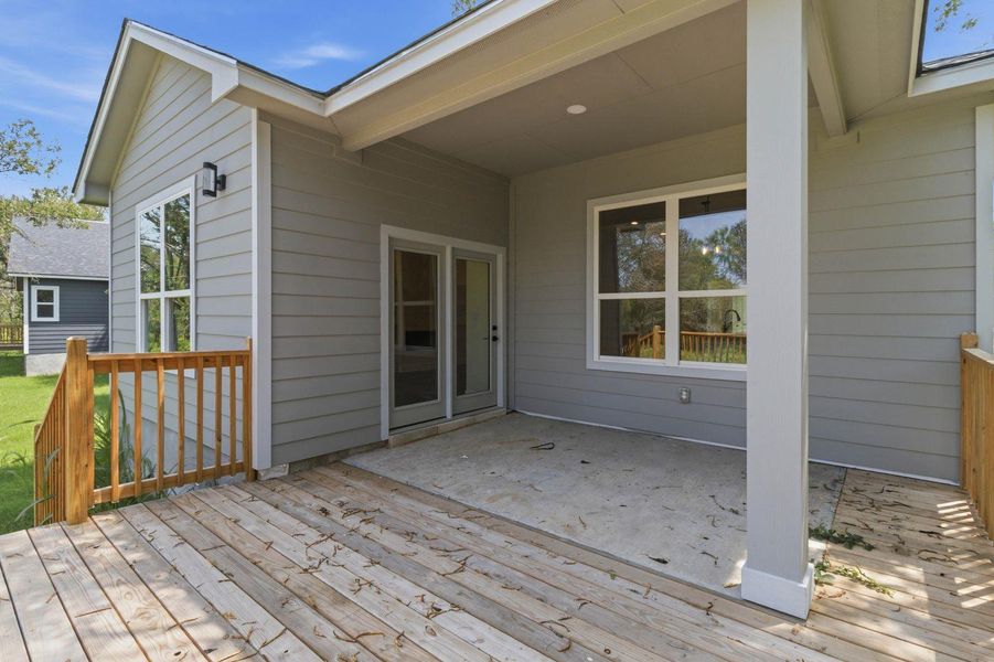 A spacious covered patio with wood decking and concrete areas offers abundant space for outdoor enjoyment. A spacious covered patio with wood decking and concrete areas offers abundant space for outdoor enjoyment.