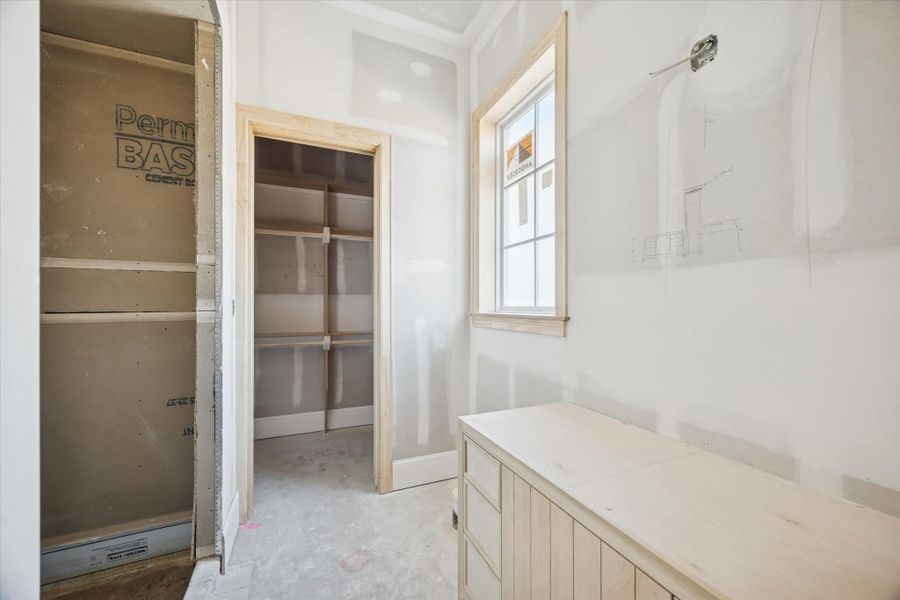 An secondary bathroom featuring space for a full vanity, linen storage, and a dedicated tub or shower. The framing and drywall work lay the groundwork for premium finishes that will blend seamlessly with the rest of the home. A functional, thoughtfully planned bath designed for daily convenience.