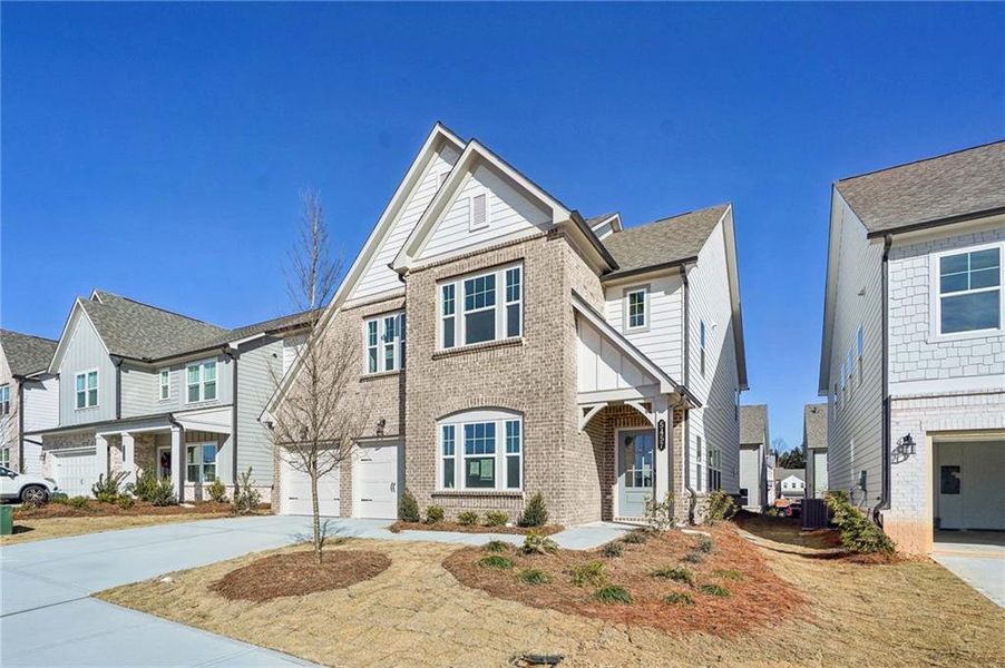 Front exterior of a new home in Eastlyn Crossing - Single Family, Flowery Branch, GA, highlighting curb appeal (Image 2). Front exterior of a new home in Eastlyn Crossing - Single Family, Flowery Branch, GA, highlighting curb appeal (Image 2).