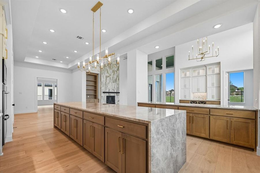 Kitchen with brown cabinetry, healthy amount of natural light, a chandelier, and recessed lighting Kitchen with brown cabinetry, healthy amount of natural light, a chandelier, and recessed lighting