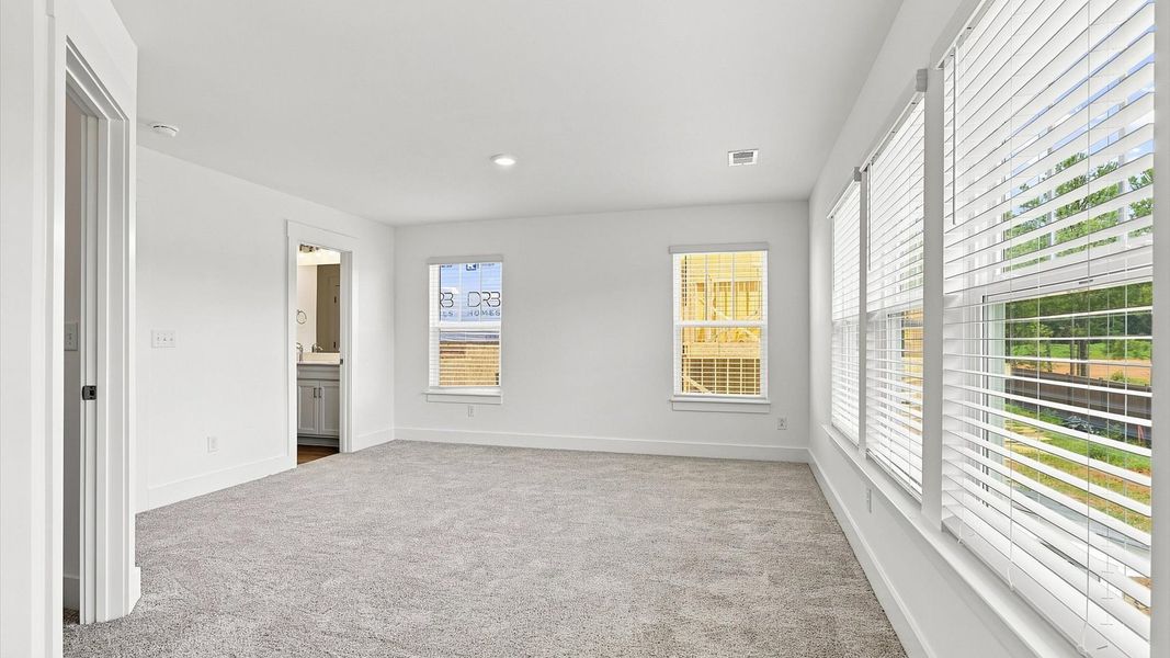 Serene and stylish primary bedroom featuring carpeted flooring and a thoughtful, modern layout at Barton Hollow Serene and stylish primary bedroom featuring carpeted flooring and a thoughtful, modern layout at Barton Hollow