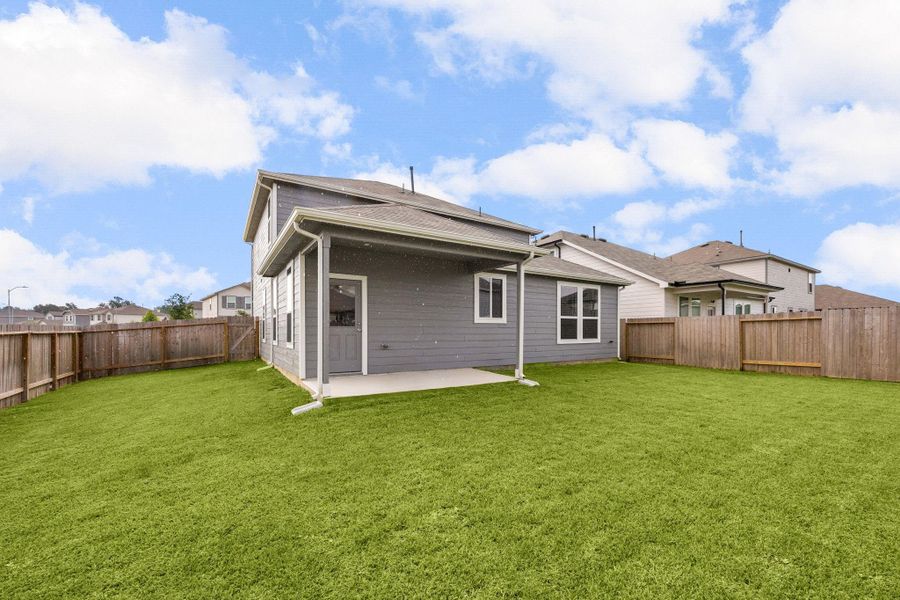 Thoughtfully designed outdoor space offers the perfect balance of usable yard and easy upkeep.