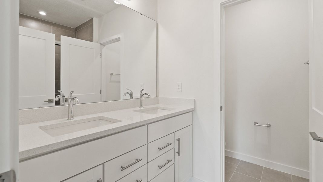 Primary En Suite Bath With Dual Sinks in the Flagler by DRB Homes in Hamilton Bluff Primary En Suite Bath With Dual Sinks in the Flagler by DRB Homes in Hamilton Bluff