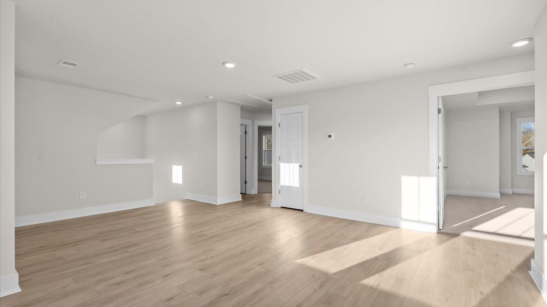 Vibrant loft with hardwood flooring and flexible space for work, play, or relaxing