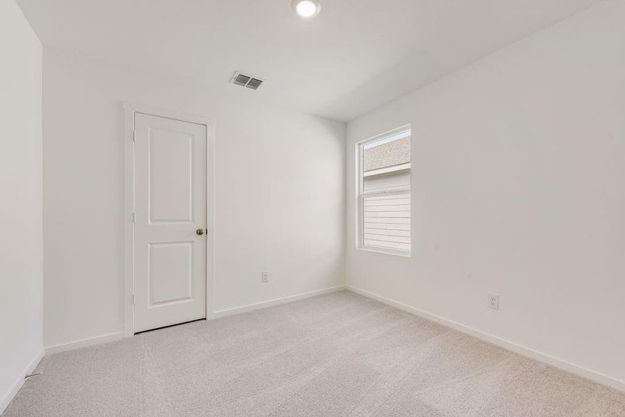 Unfurnished room with light carpet and baseboards