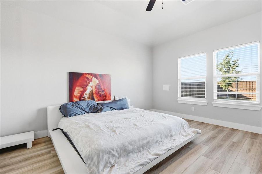 Bedroom featuring light wood-type flooring and ceiling fan