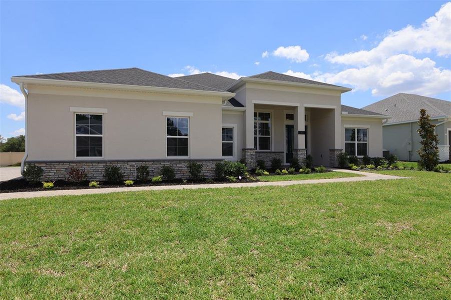 Front exterior of a new home in Willow Run, Apopka, FL, highlighting curb appeal (Image 6). Front exterior of a new home in Willow Run, Apopka, FL, highlighting curb appeal (Image 6).