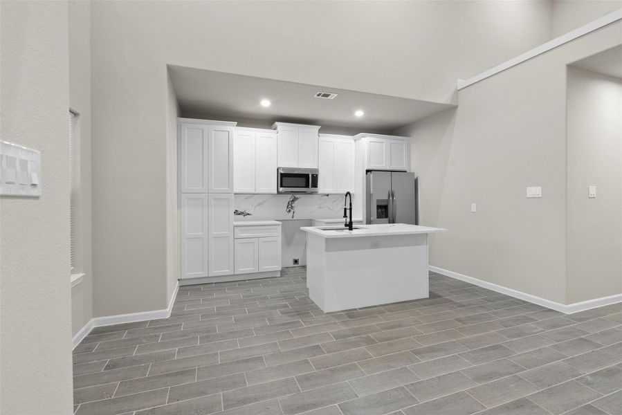 View from the front door to kitchen and breakfast bar View from the front door to kitchen and breakfast bar