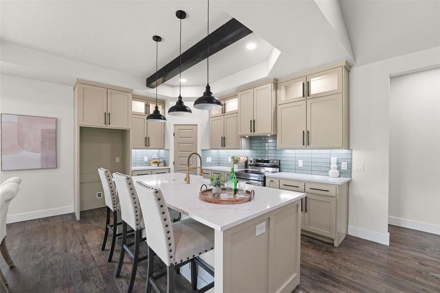 Contemporary kitchen featuring an expansive island with a quartz countertop, under-cabinet lighting, a subway tile backsplash, recessed lighting, and wood-finish flooring Contemporary kitchen featuring an expansive island with a quartz countertop, under-cabinet lighting, a subway tile backsplash, recessed lighting, and wood-finish flooring