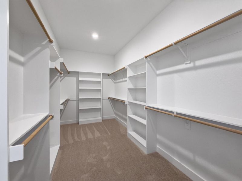 Ample shelving and hanging space defines this generously sized walk-in closet.
