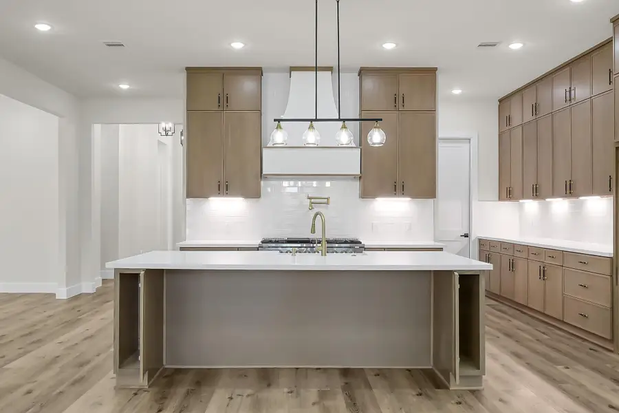 Hidden storage in the kitchen island is perfect for stowing away cookie sheets or other hard to stash items.