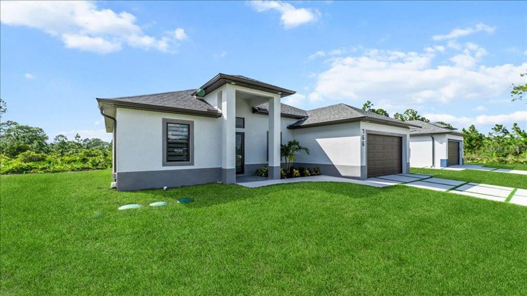 Front exterior of a new home in , Lehigh Acres, FL, highlighting curb appeal (Image 26).