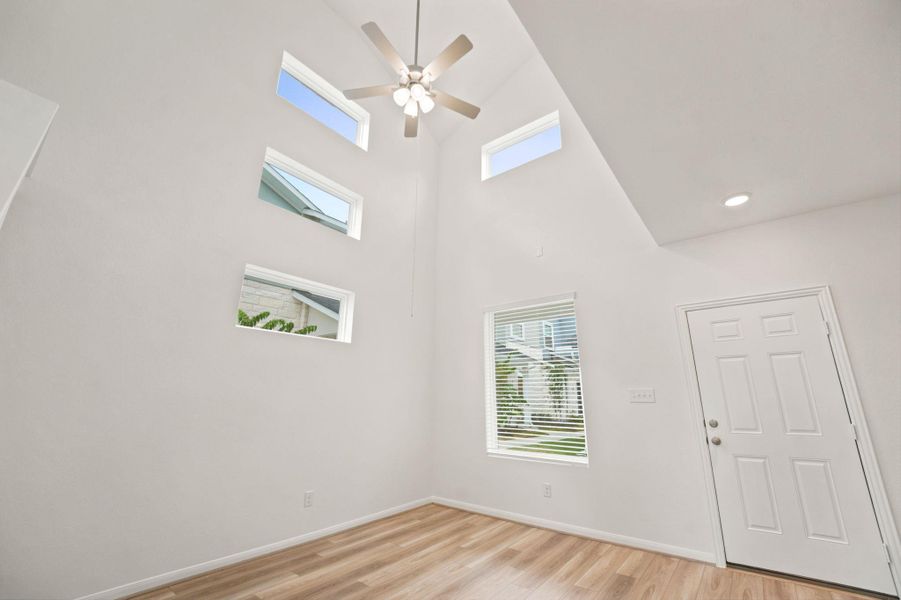 High vaulted ceilings and wood floors define this architectural entry.