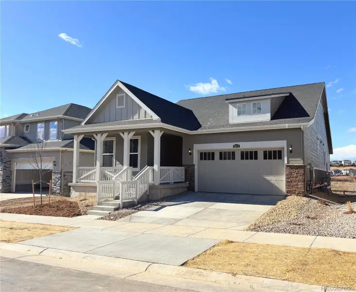 Front exterior of a new home in Newlin Crossing, Parker, CO, highlighting curb appeal (Image 1). Front exterior of a new home in Newlin Crossing, Parker, CO, highlighting curb appeal (Image 1).