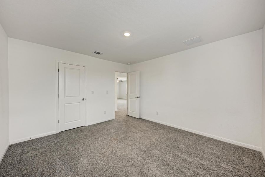 A spacious room offers new carpeting and freshly painted walls, creating a clean canvas.