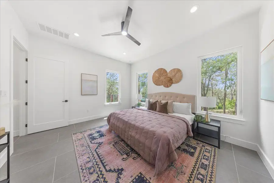 Tiled bedroom with multiple windows, recessed lighting, and ceiling fan Tiled bedroom with multiple windows, recessed lighting, and ceiling fan