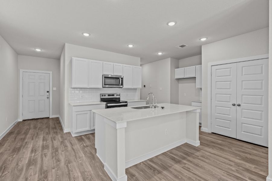 A kitchen with white cabinets. A kitchen with white cabinets.