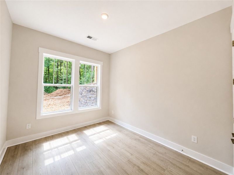A well-lit room awaits your personal touch, offeri