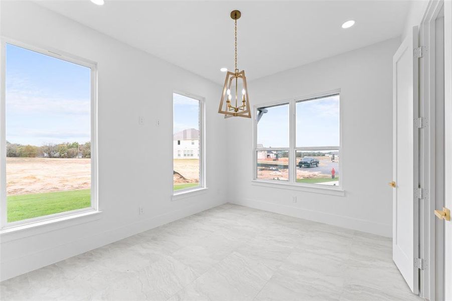 Unfurnished dining area featuring a chandelier and recessed lighting