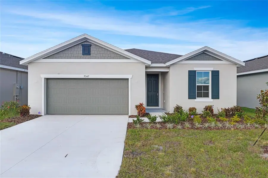 Front exterior of a new home in , Winter Haven, FL, highlighting curb appeal (Image 1). Front exterior of a new home in , Winter Haven, FL, highlighting curb appeal (Image 1).