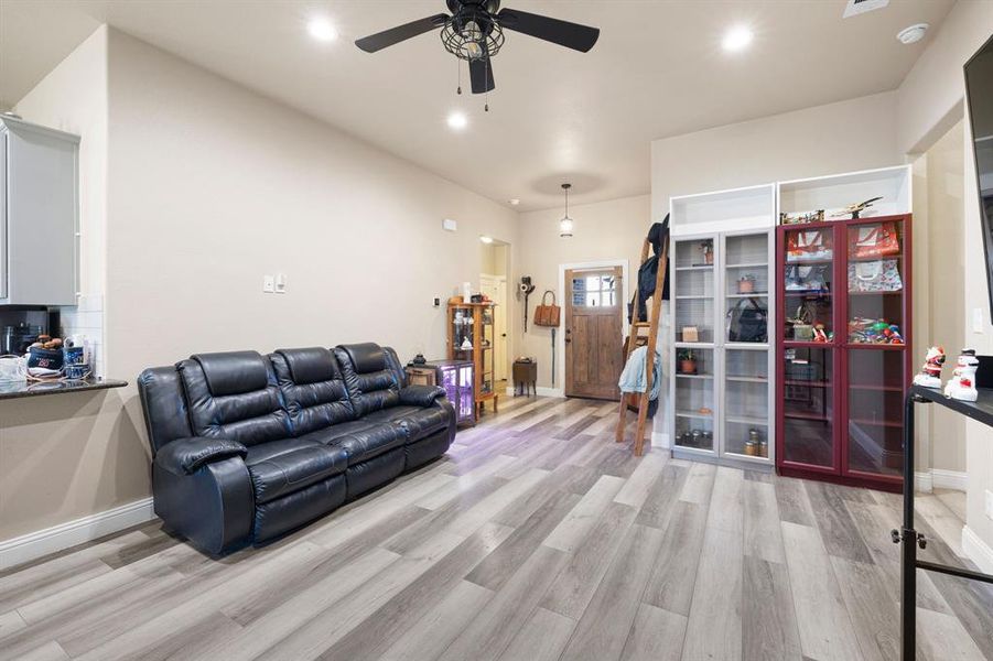 Living room featuring ceiling fan and light wood-type flooring