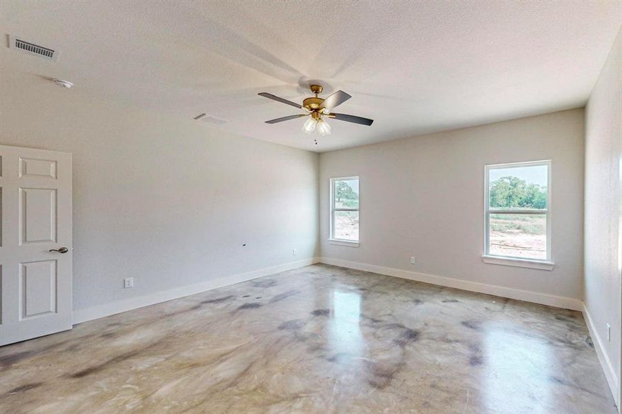 Unfurnished room featuring ceiling fan and a textured ceiling