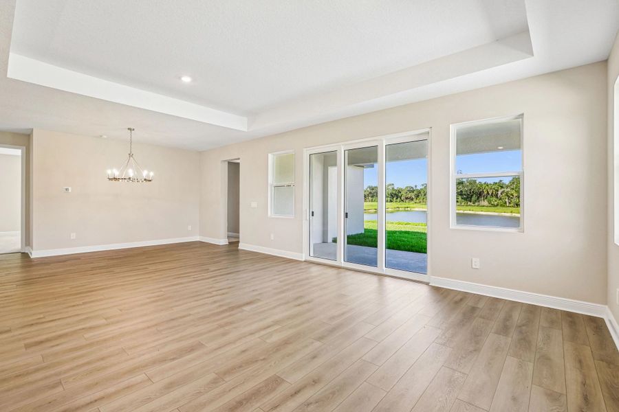 The dining space opens up into the family room space which features a tray ceiling